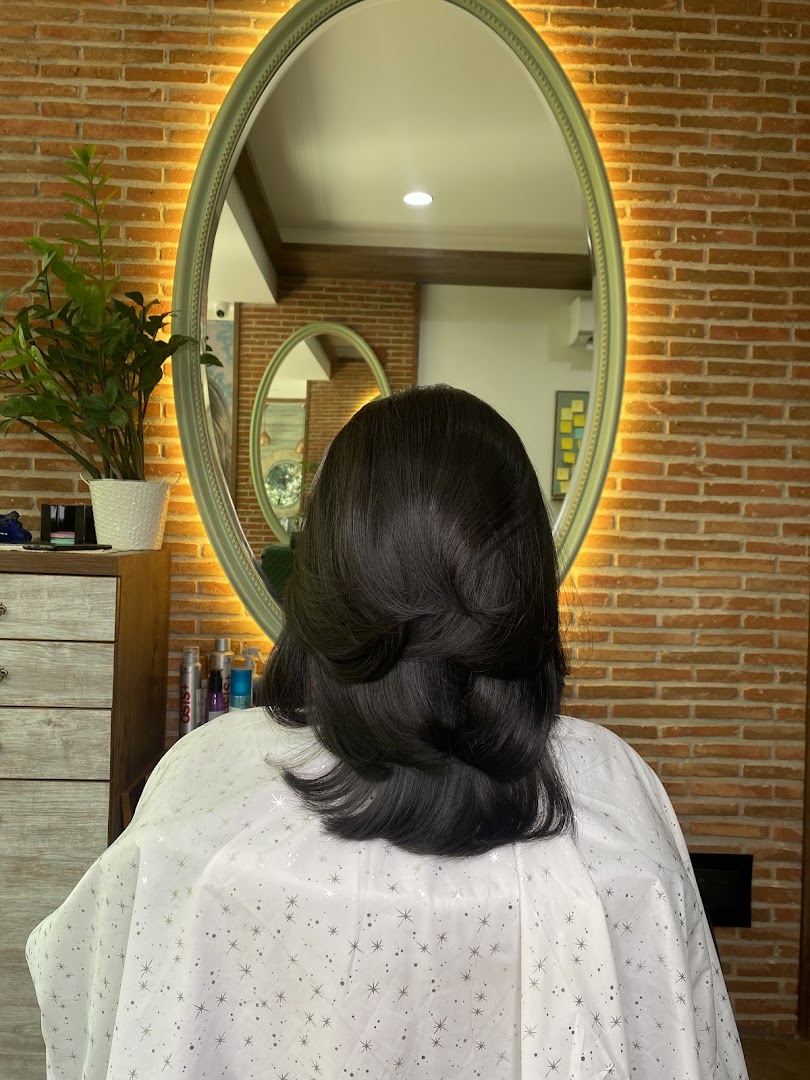 A mid-length layered cut styled under the halo mirror